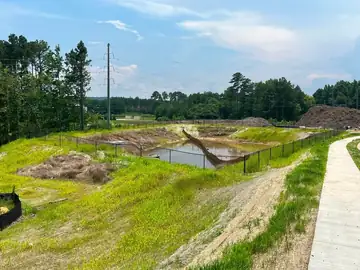 Fenced detention basin on a development under construction