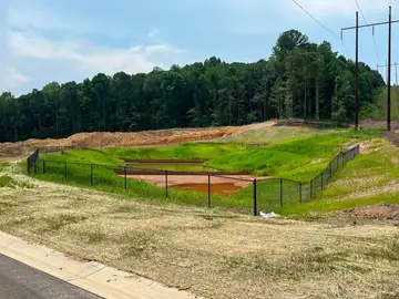 Black safety fence around a stormwater basin