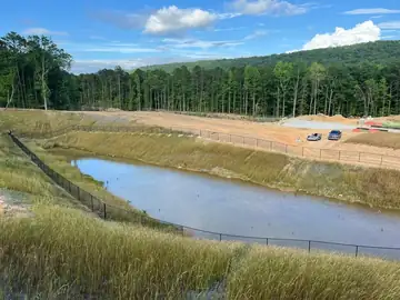 Long fence line around a stormwater basin on a development