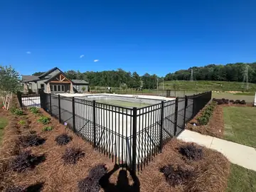 Black aluminum pool enclosure at a modern Alabama home