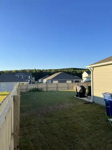Wood privacy fence around a sodded back yard
