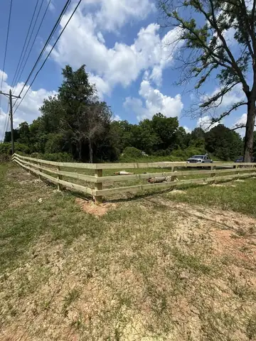 Split rail fence across an open rural lot