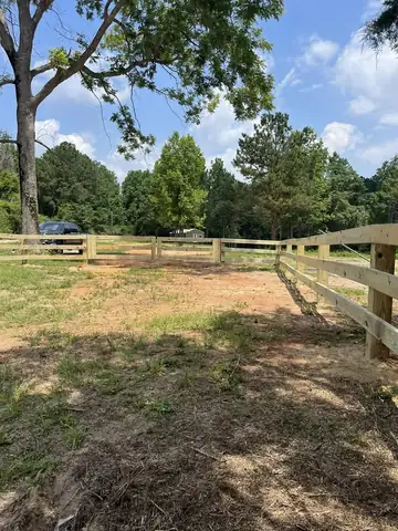 Post and rail fence around a pasture