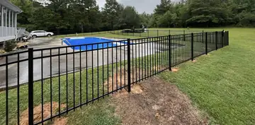 Black aluminum fence beside a swimming pool