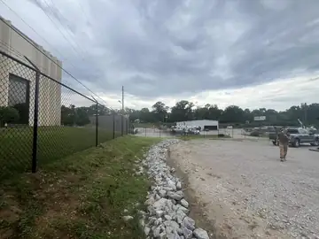 Black chain link fence beside a commercial building