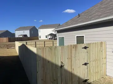 Wood privacy fence and gate between two houses