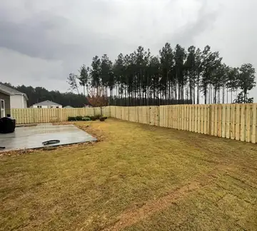 Wood fence enclosing a large back yard