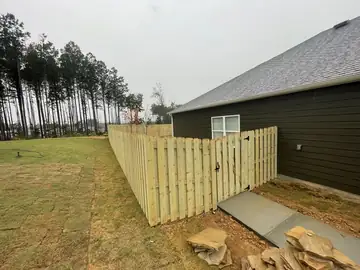 Wood privacy fence stepping down a slope