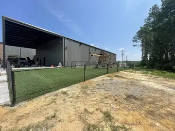 Black chain link fence enclosing a yard at a commercial building