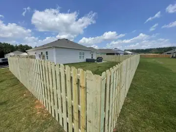 Spaced picket fence around a suburban back yard