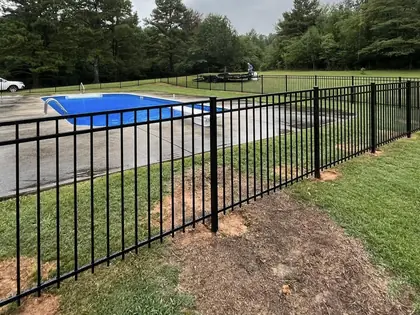 Black aluminum ornamental fence enclosing a swimming pool at a modern Alabama home