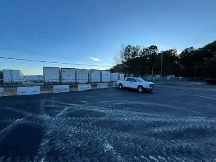 Commercial chain link perimeter fence and drive gates at a storage facility